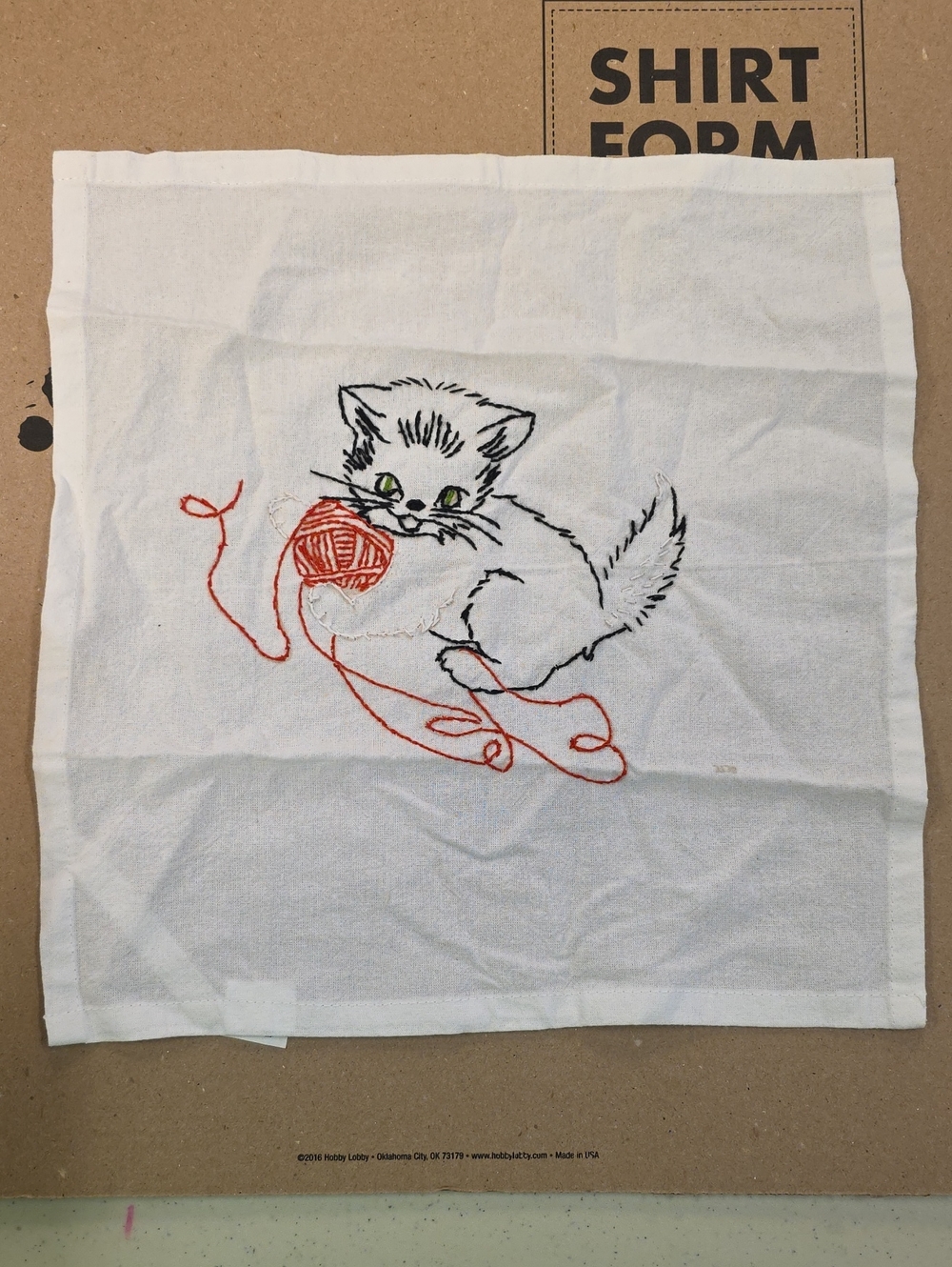 White Embroidered Kitten Cloth with Red Yarn Accent